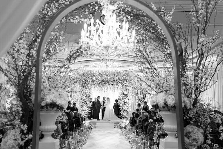 Black and white image of an elegant indoor wedding and chapel
