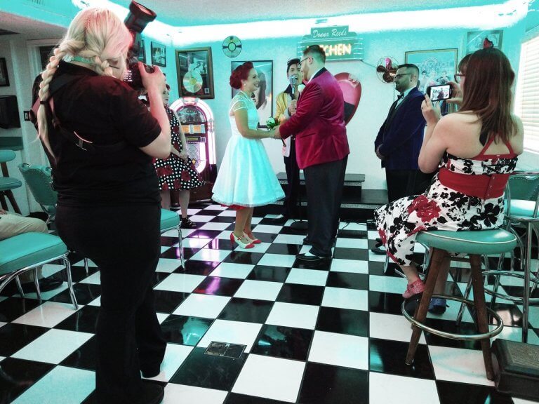 A couple getting married in a 50's style wedding chapel