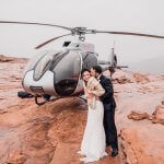 Wedding couple in front of a helicopter