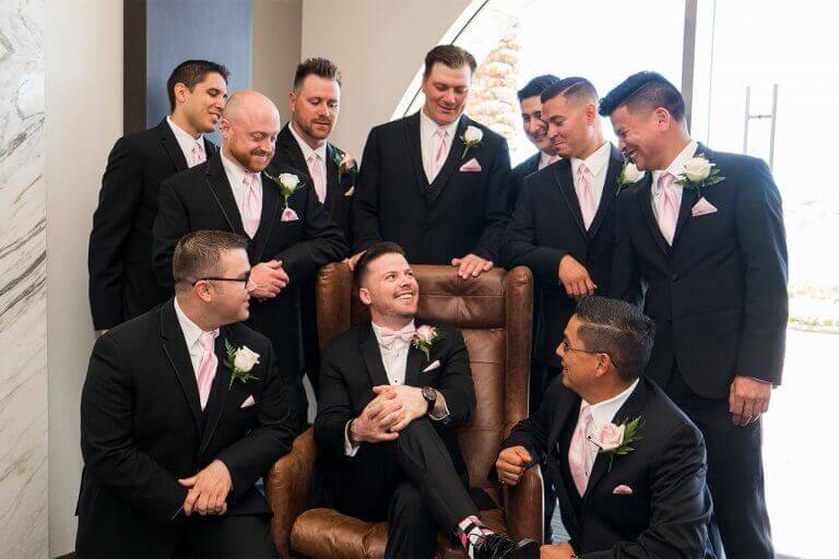 A groom and groomsmen chatting and laughing