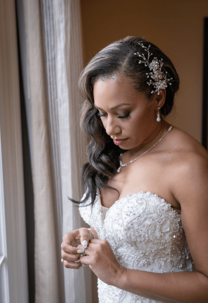A bride exhibits beautiful wedding hair and makeup