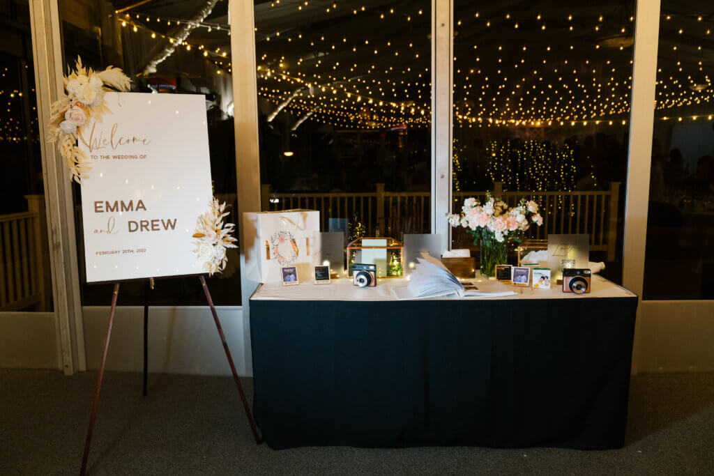 a guestbook table with cameras and books