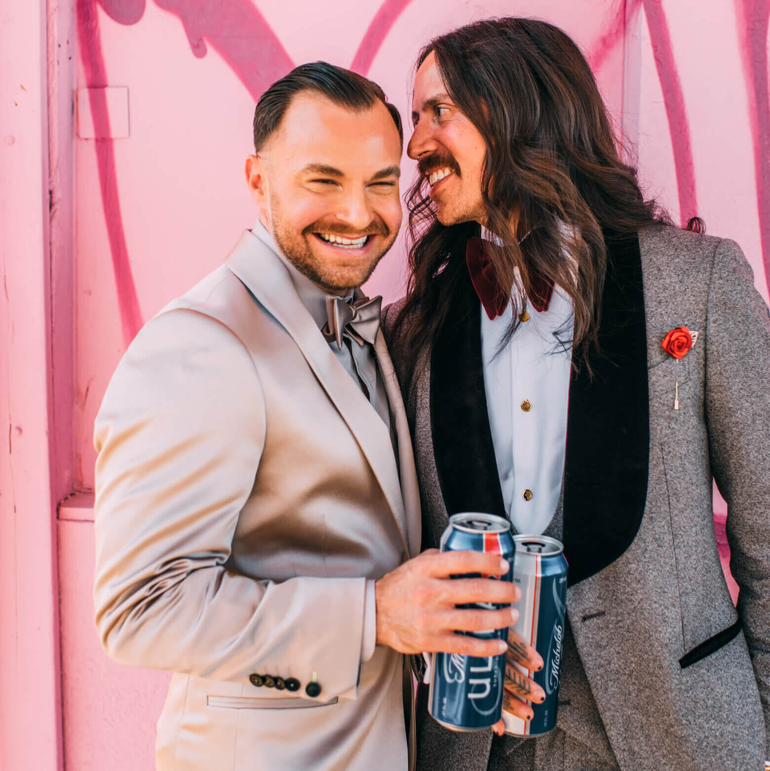 two wedding grooms enjoying a beer