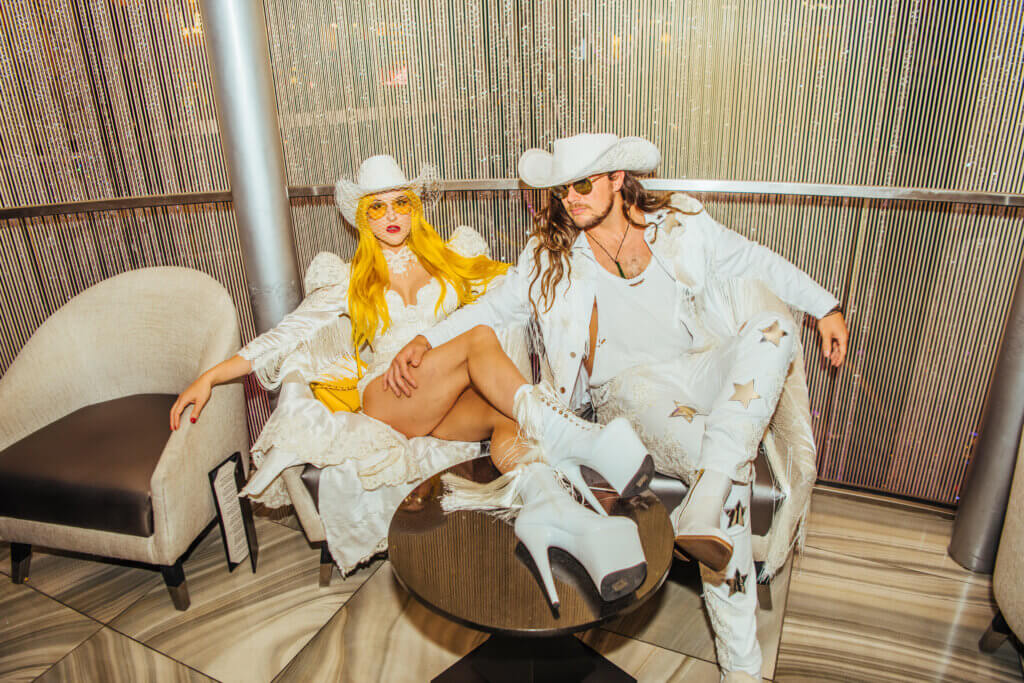a cowboy couple in hats and white outfits