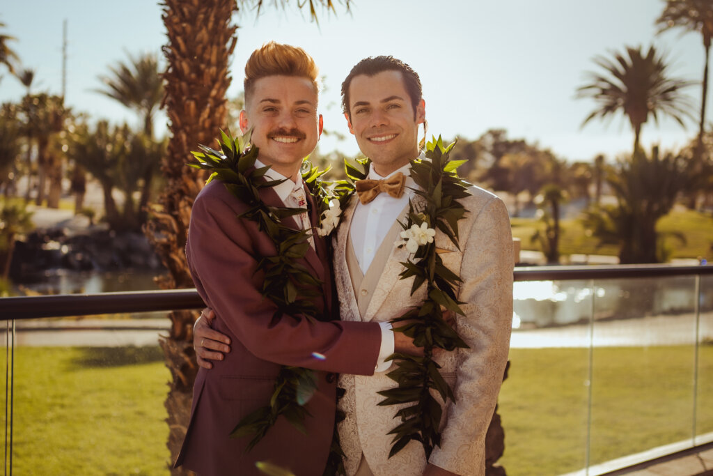 two grooms in tropical garb