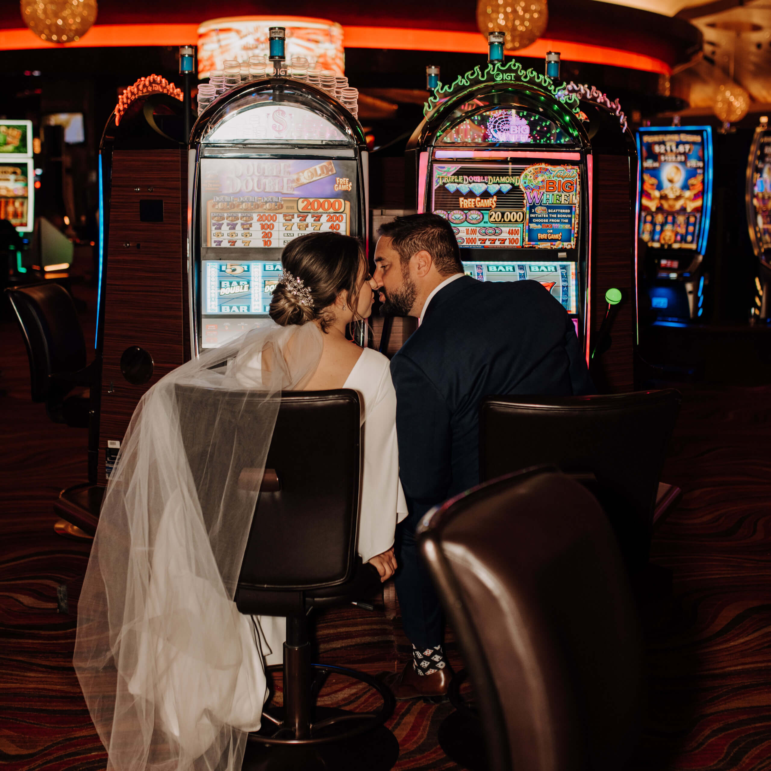 a wedding couple sits down at the casino