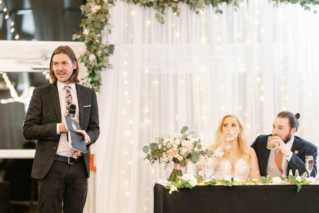 speeches at a wedding with twinkle lights