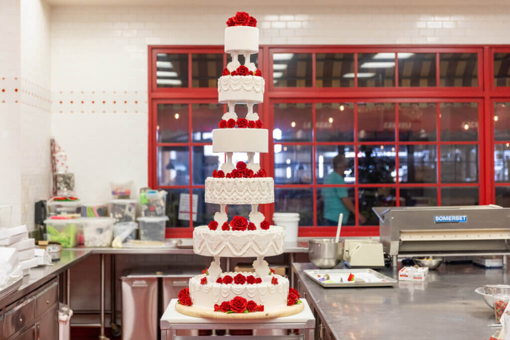 full shot of a white cake with red roses