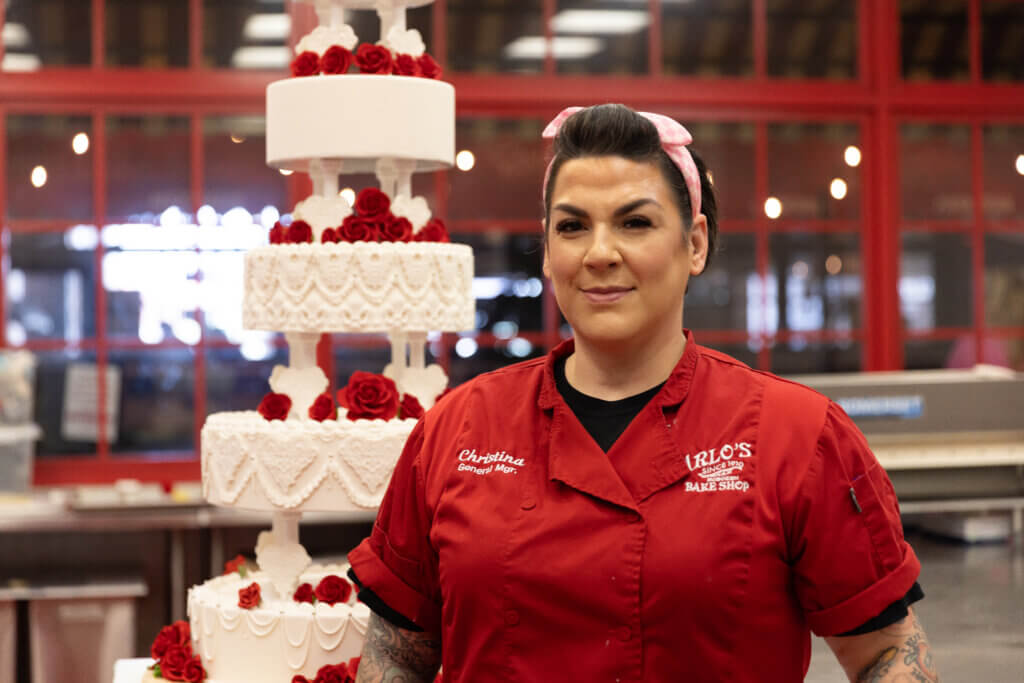 Christina Nasso standing beside the Elvis Presley wedding cake