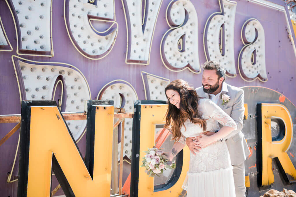 a happy couple at the Neon Museum