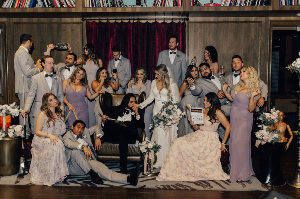 A bride and groom surrounded by family and friends