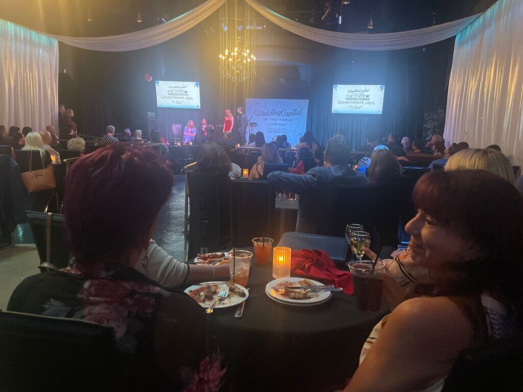 people sitting at tables listening to tourism talks