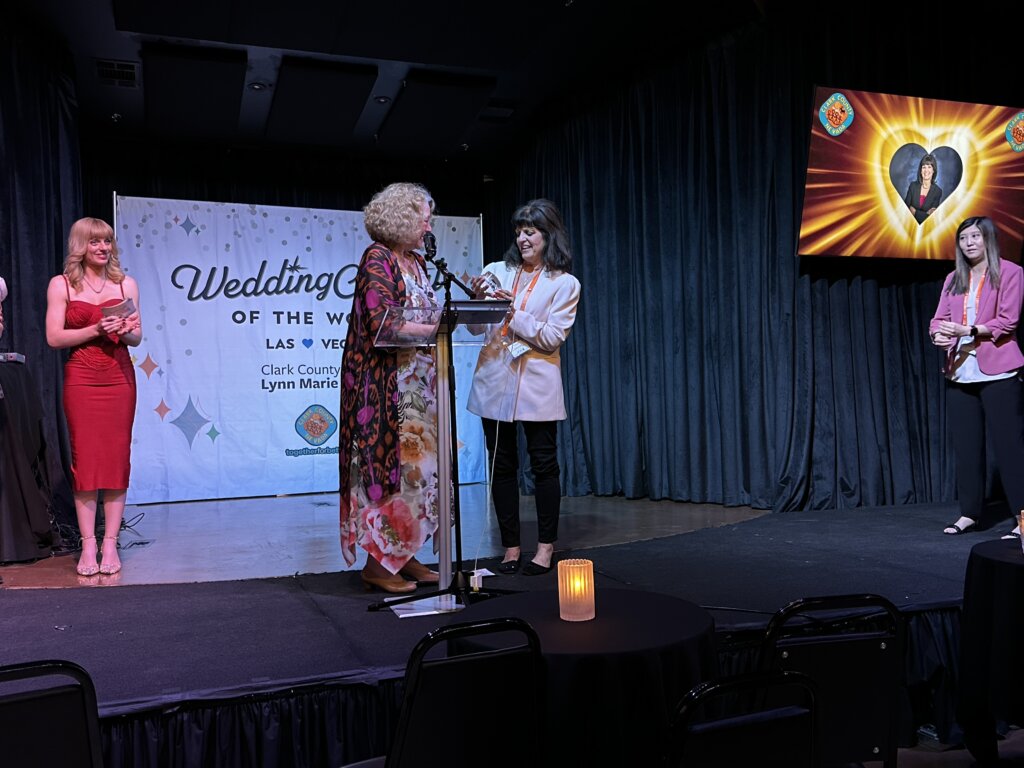 two women exchanging an award