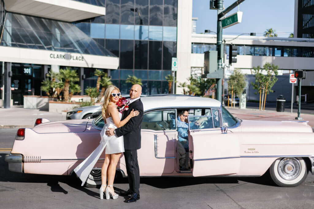 the Womack couple in front of a pink car