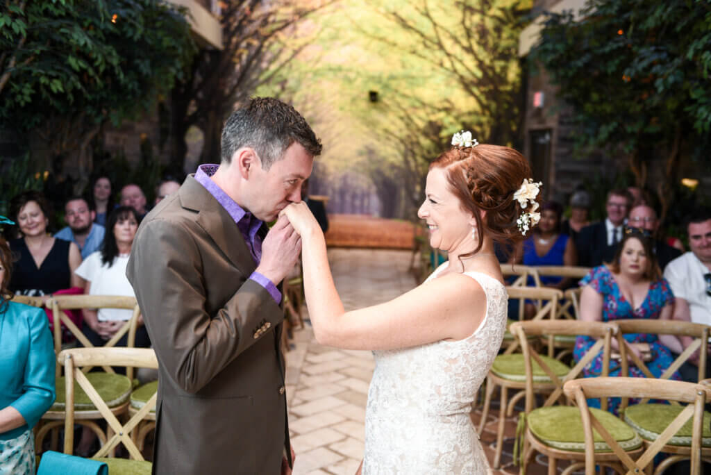 a man kisses a woman on the hand