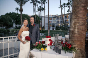 a couple standing with a cake