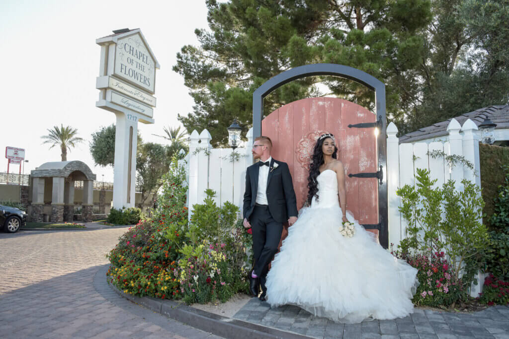 a Libra wedding season ceremony in front of a gate fence