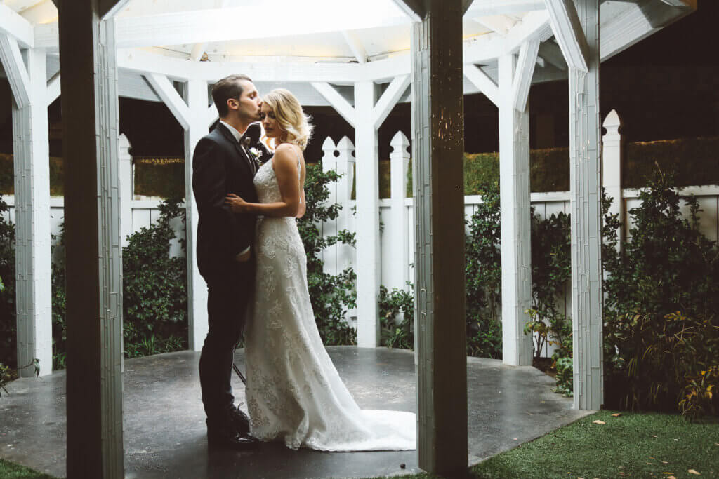 a couple standing under a gazebo