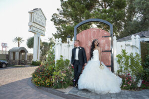 a couple in front of a wooden gate door