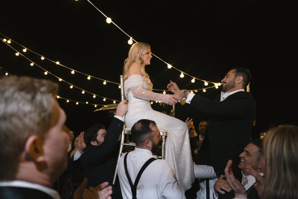  a bride on a chair at her wedding