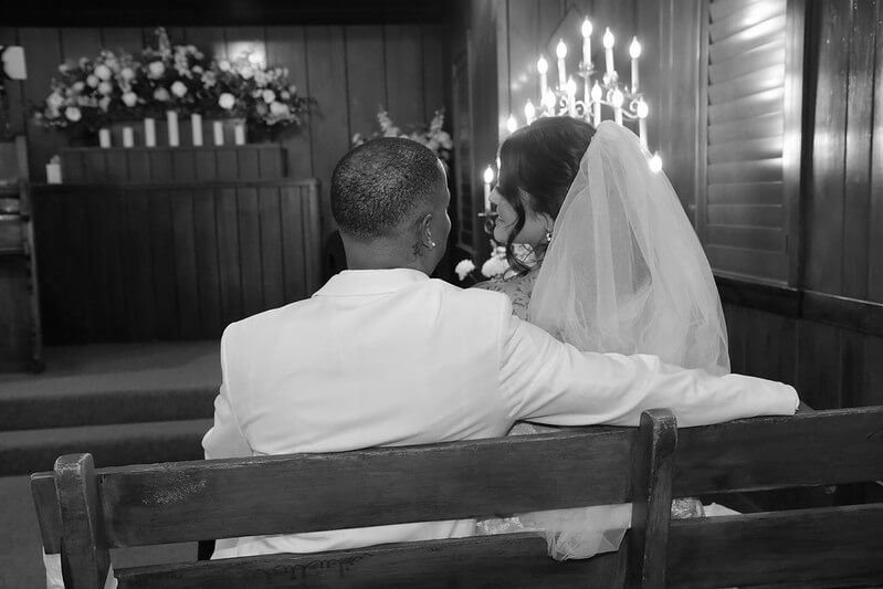 a couple sitting in a pew at Las Vegas Marries the Military