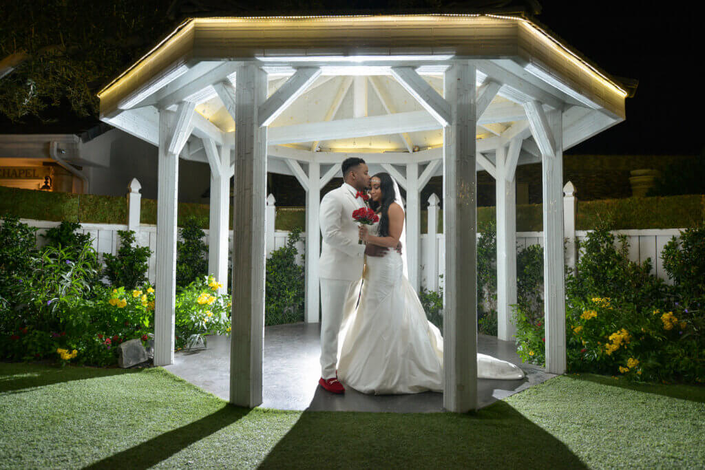 a couple with red flowers in a gazebo