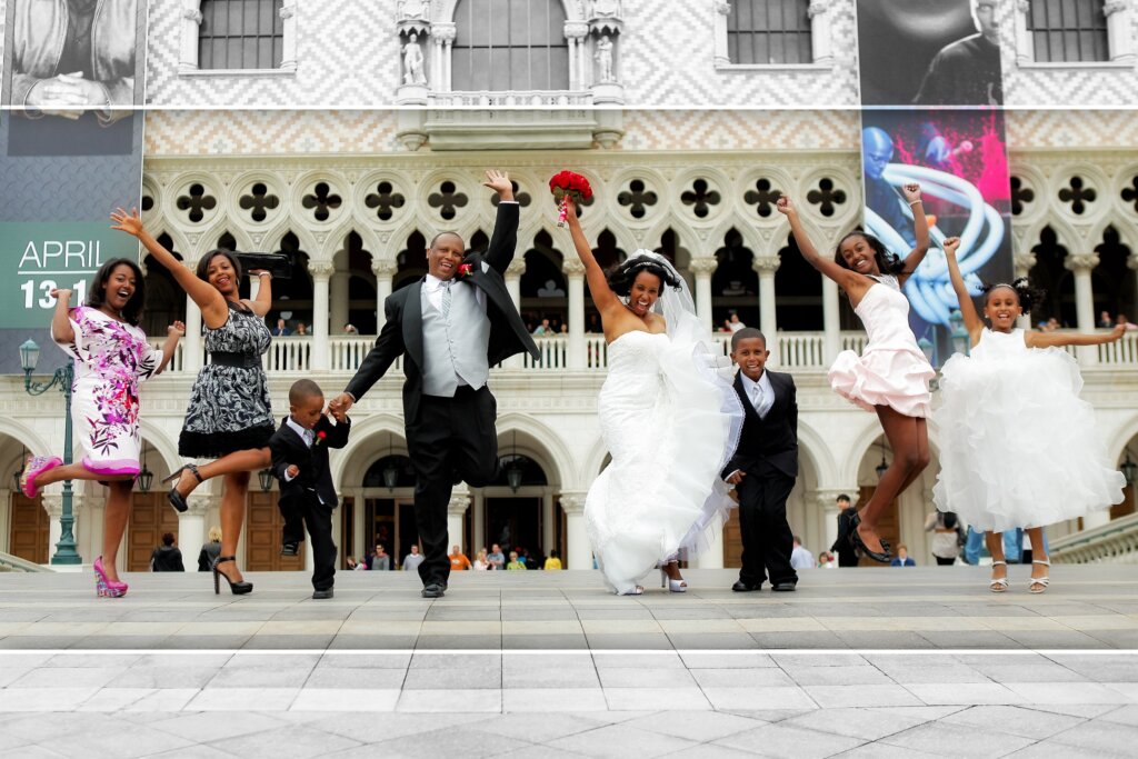 a wedding couple and their family jumping in Las Vegas