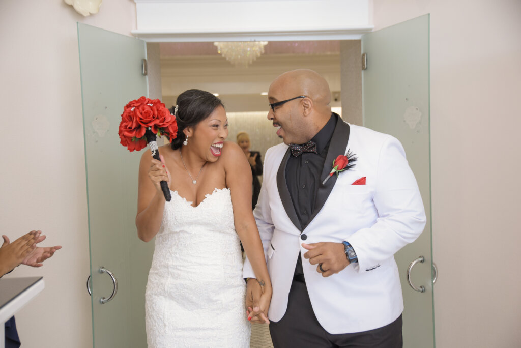 a couple walking out of a wedding chapel