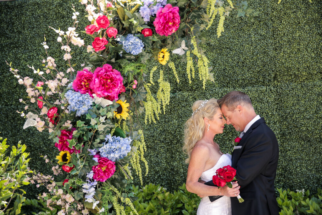a floral arrangement next to a wedding couple