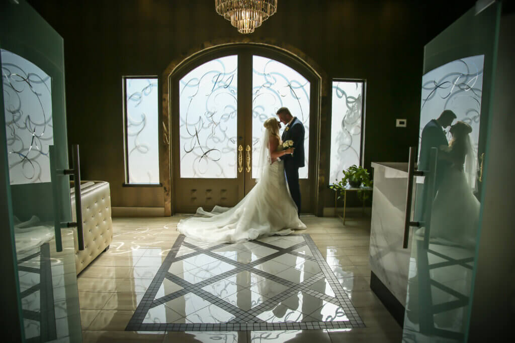 a couple kissing in a chapel for Vegas wedding packages