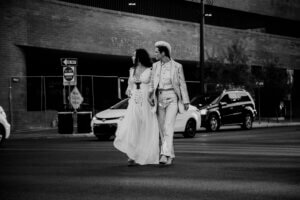 a rock star wedding couple crossing the street