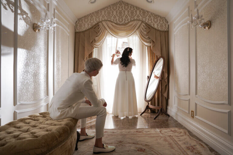 a wedding couple wearing white in a mirror room