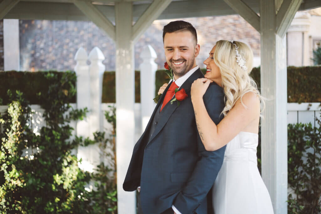 a bride with her chin on the groom's shoulder at a Gemini wedding