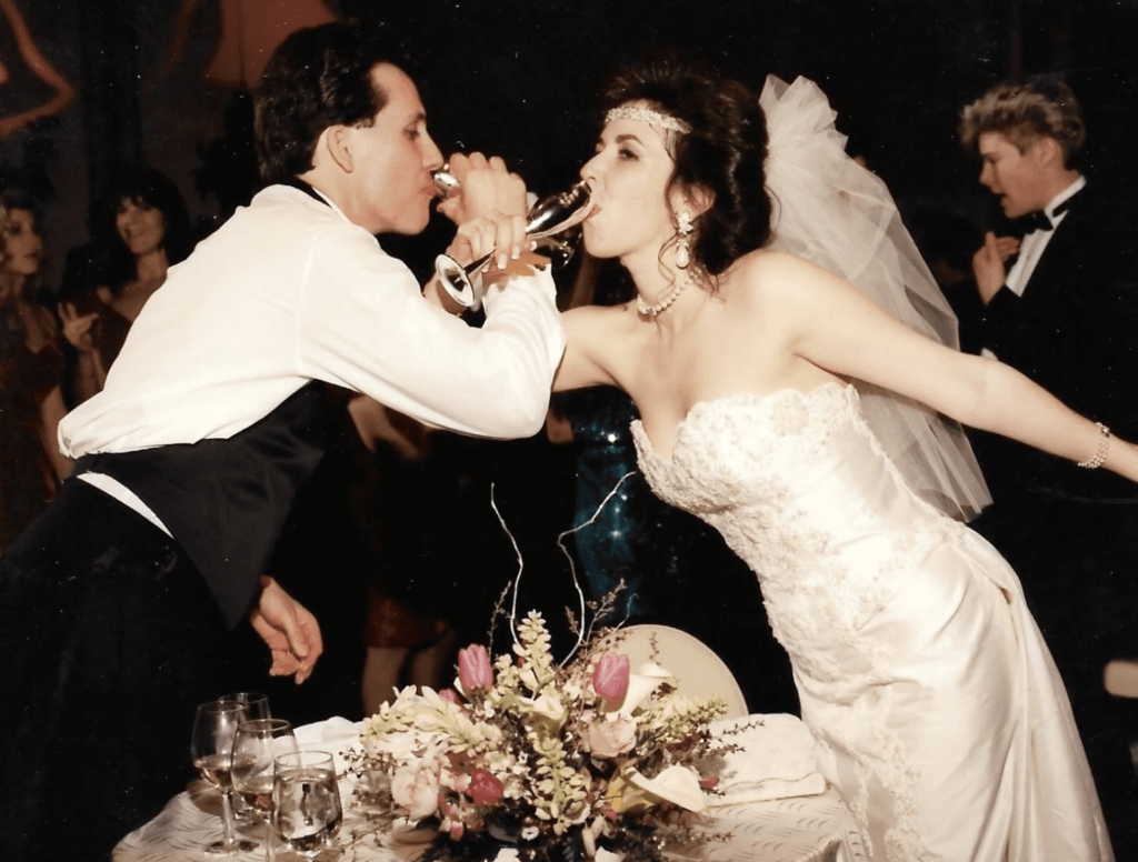 Dawn and Christopher Hume toasting on their wedding day