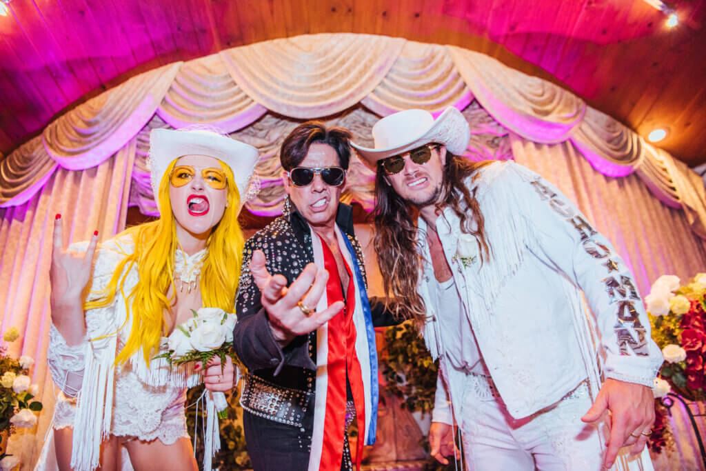 a Western wedding couple with Elvis officiant