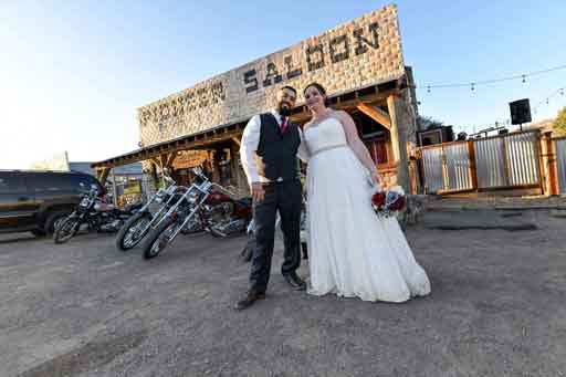 Bride and groom on their wedding day outside the Pioneer Saloon
