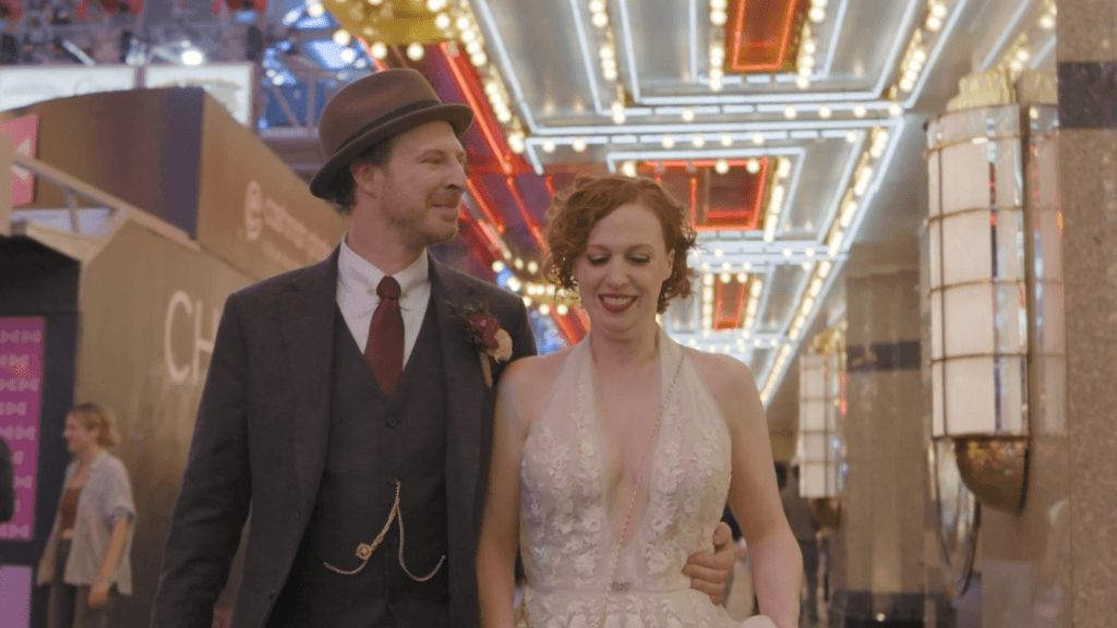 Stephanie and Britt walking down Fremont Street in their wedding attire